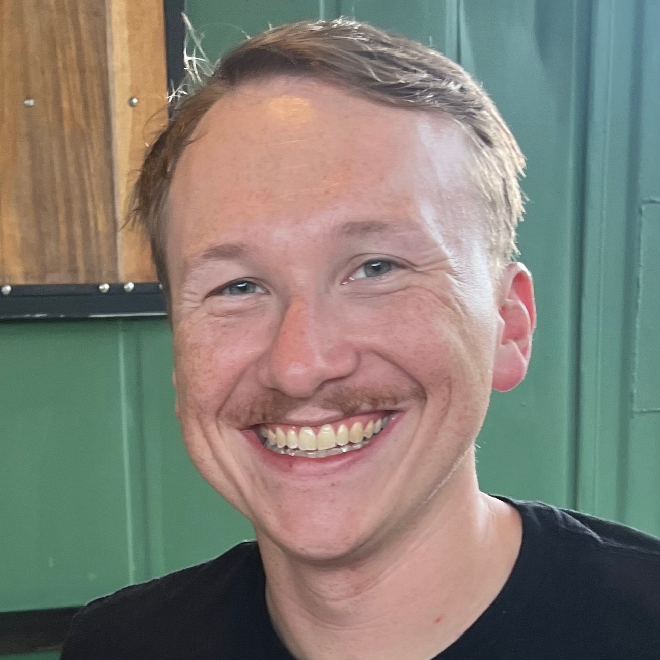 A picture of Colin with a cheesehead on, preparing to watch his beloved Packers lose once again in the playoffs